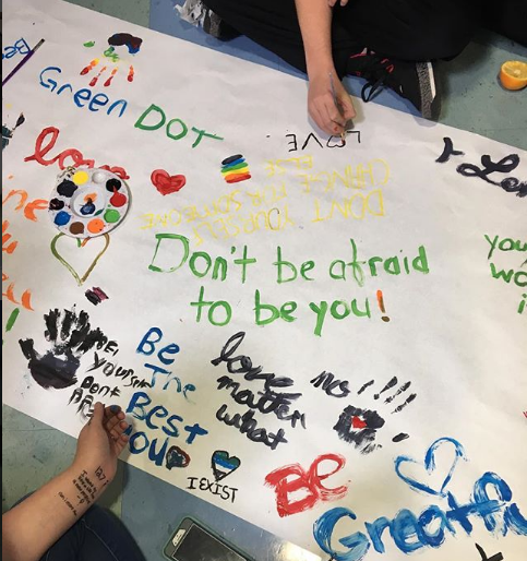 Students collaborate on an art project with a violence prevention message