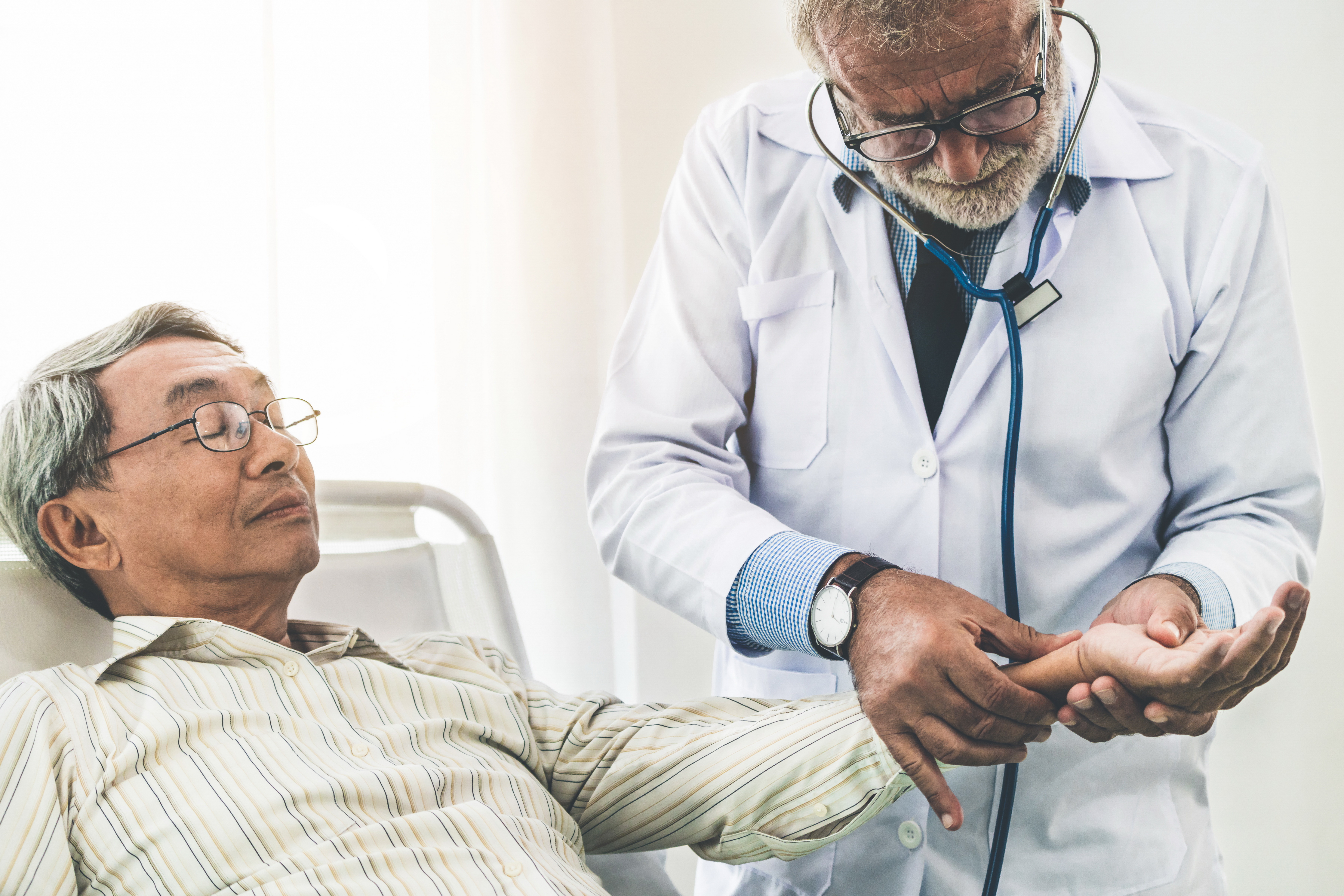 A doctor checks a patient's pulse