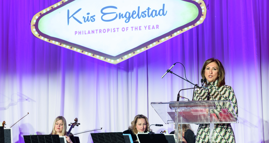 Photo of Kris Engelstad accepting her award.
