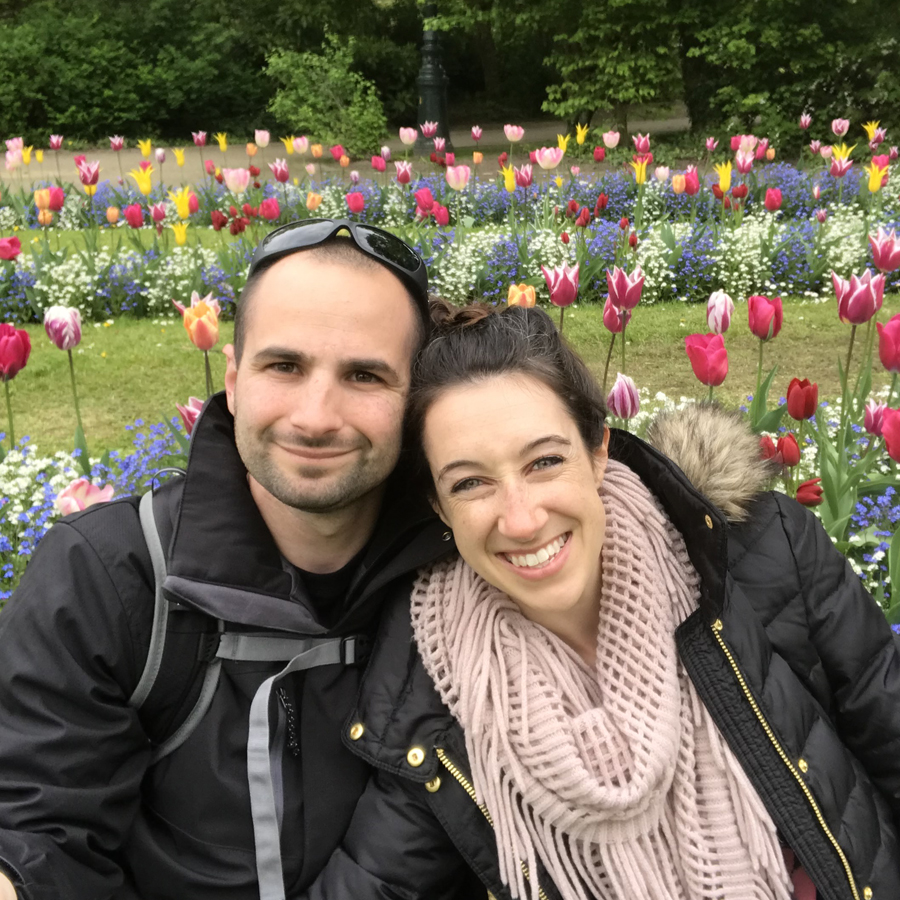 Photo of Anthony Pagliaro and another adult in a field of flowers.