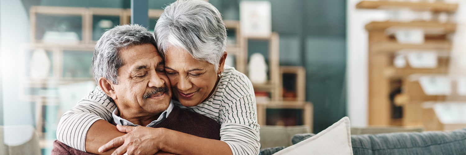 Two adults embrace.